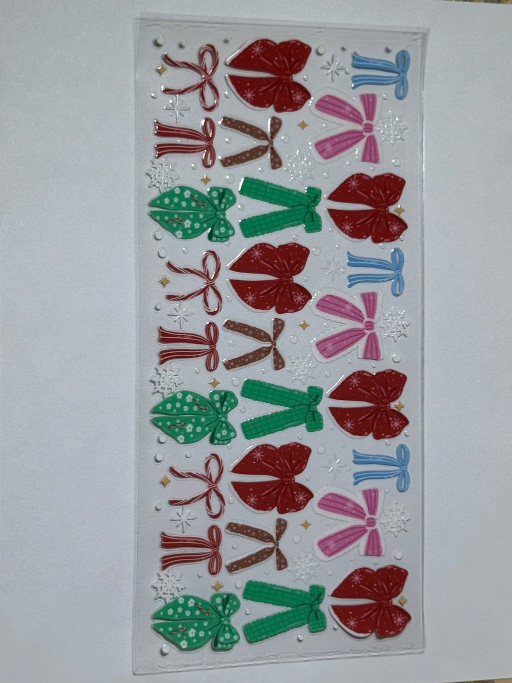 Sheet of decorative bows with red, green, and pink colors on a white card.